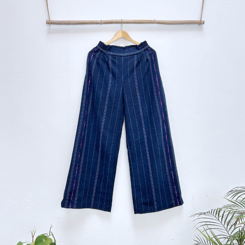 Blue striped pants on a hanger against a white background