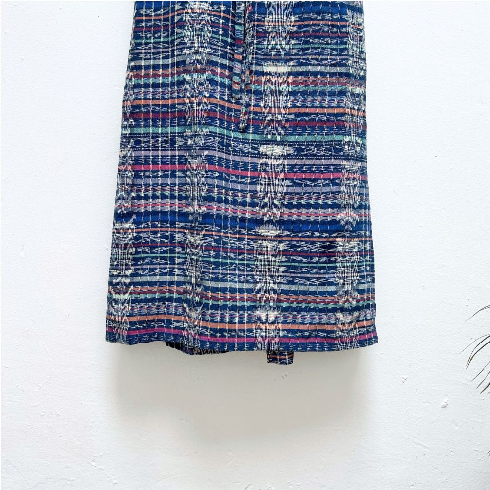 Fabric with blue and purple ikat pattern on a white background