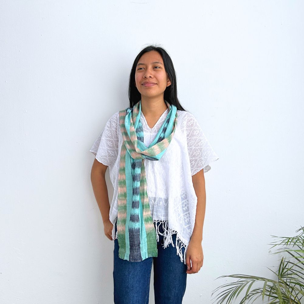 Woman wearing a colorful scarf against a white background