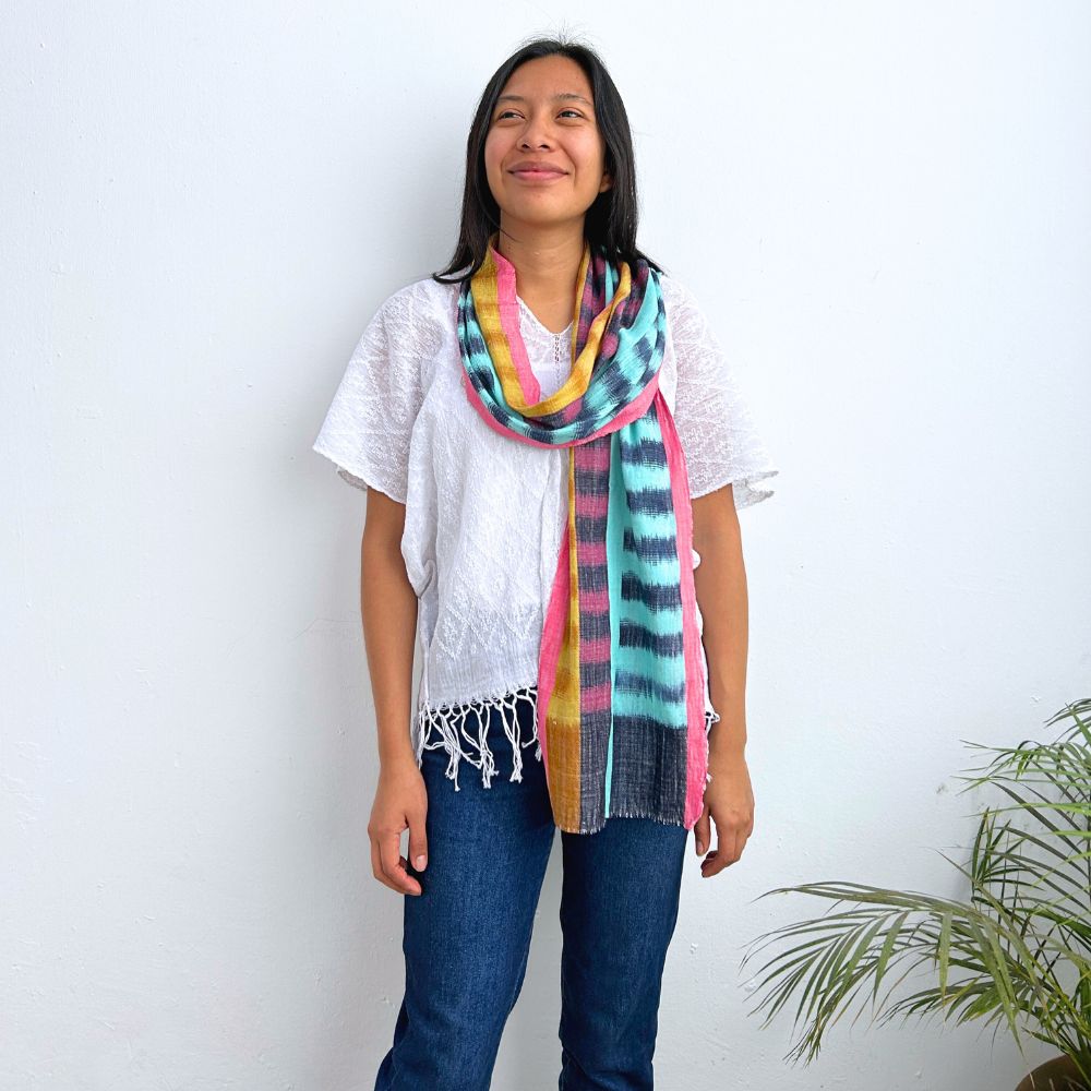 Woman wearing a colorful scarf with a white background