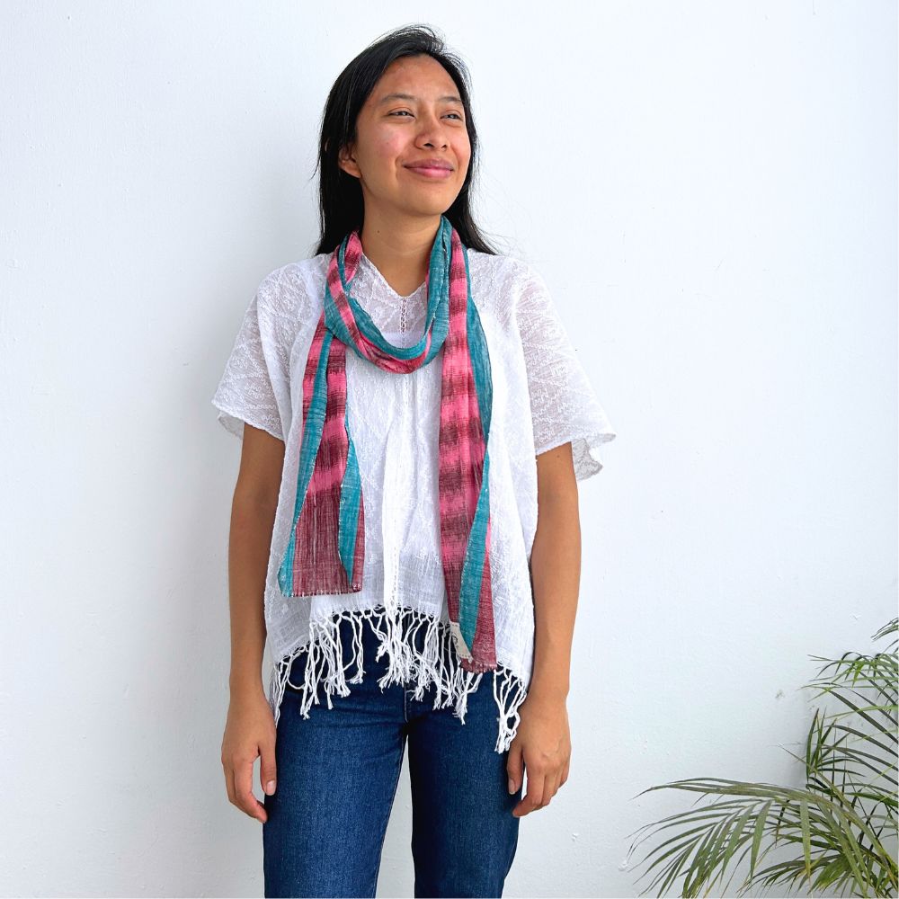 Woman wearing a colorful scarf with a white background