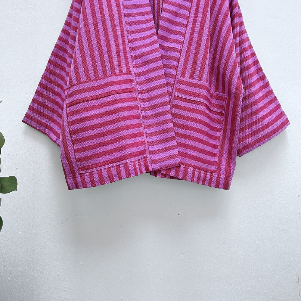 Pink and purple striped fabric on a white background