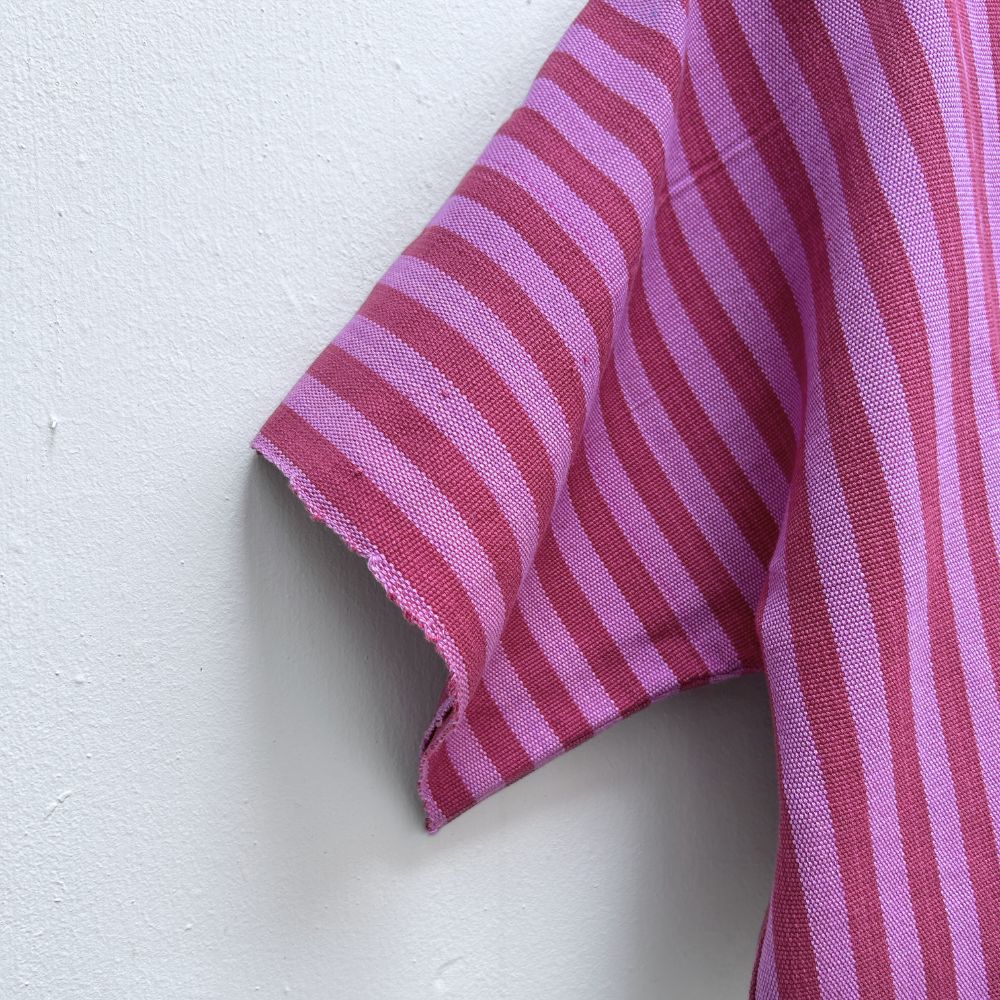 Close-up of a sleeve of a  Two Shades of pink striped cropped jacket