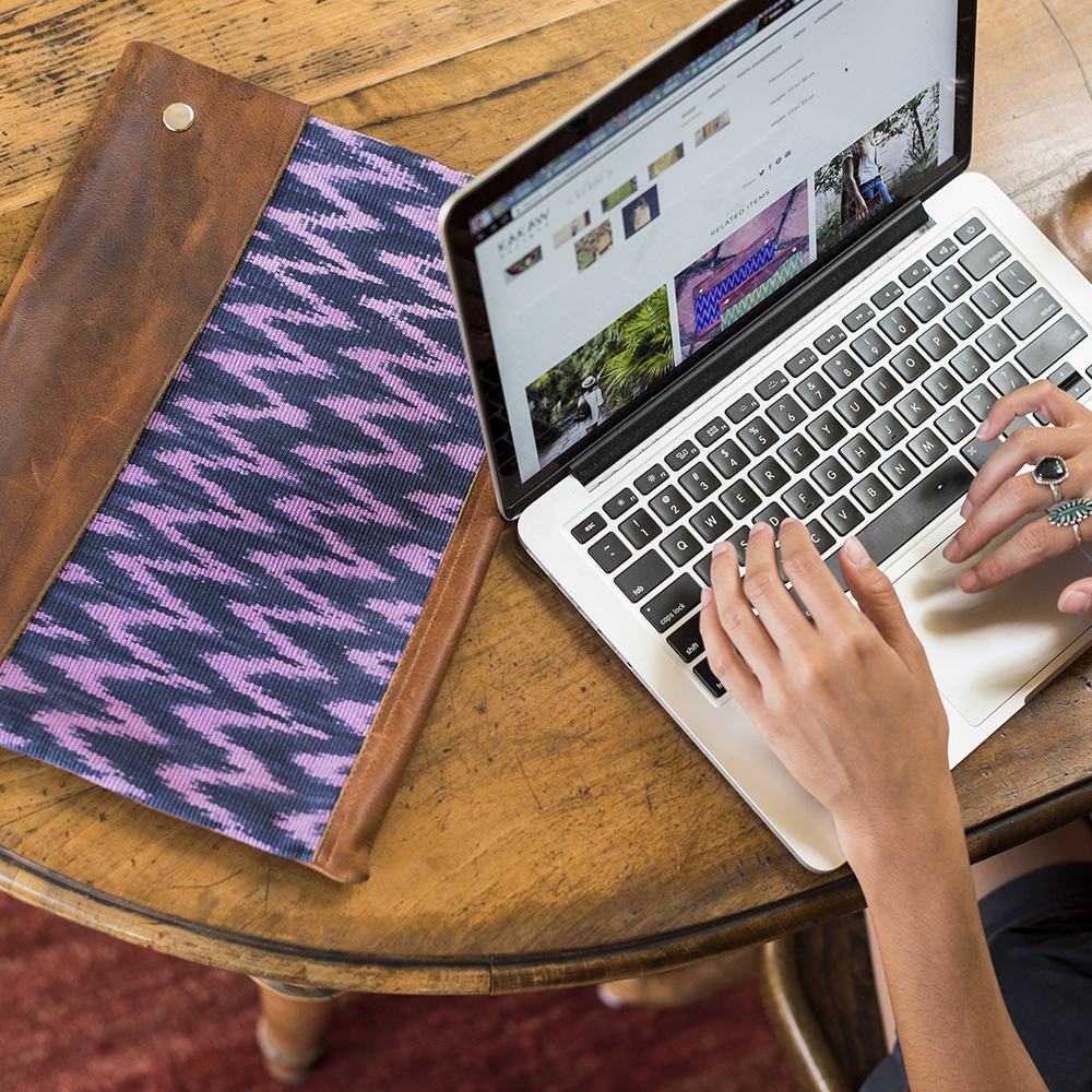 Naturally-dyed and handwoven textile laptop sleeve with leather
