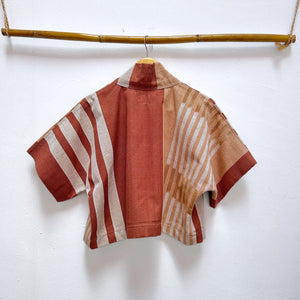 Striped shirt with red and beige pattern on a white background