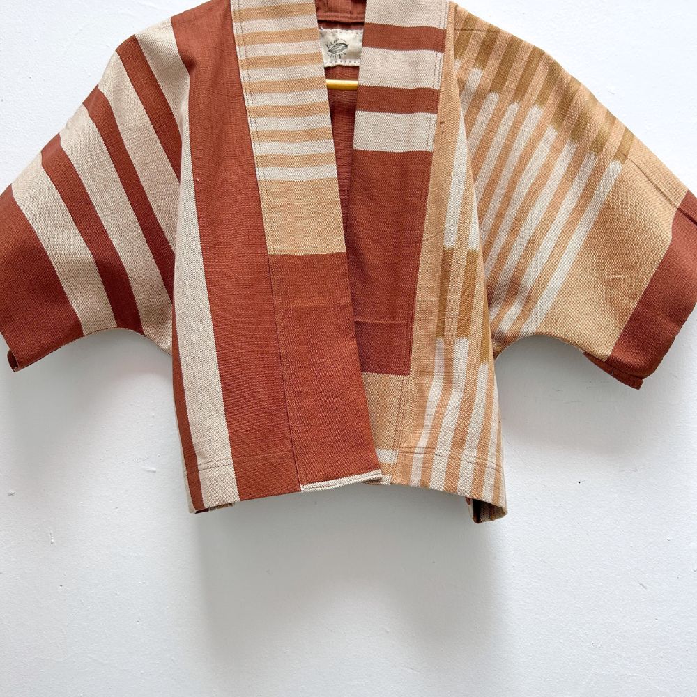 Brown and beige striped jacket on a white background