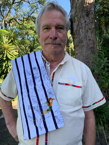 Man holding a work in progress embroidered pants