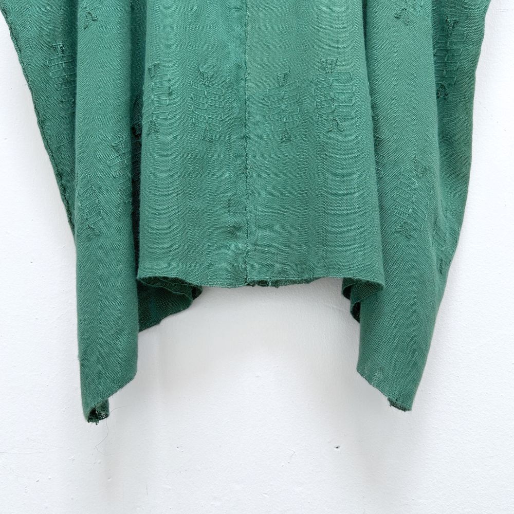 Green woven blouse with brocade patterns on a white background