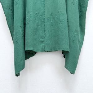 Green woven blouse with brocade patterns on a white background