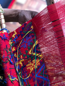 A detailed view of colorful brocade on a backstrap loom.