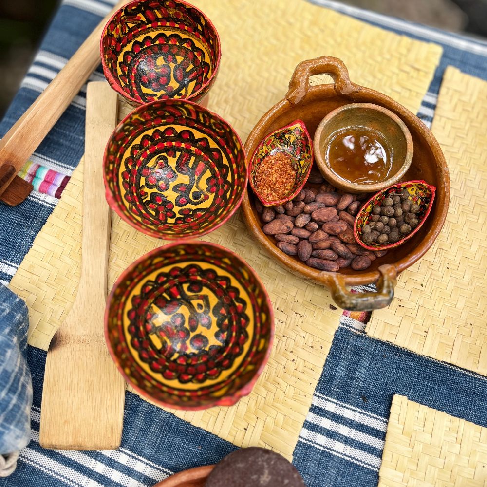 Decorative hand-painted bowls with various ingredients on a woven surface