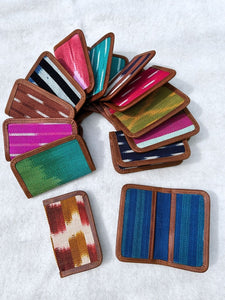 Colorful woven card holders arranged in a circular pattern on a white background