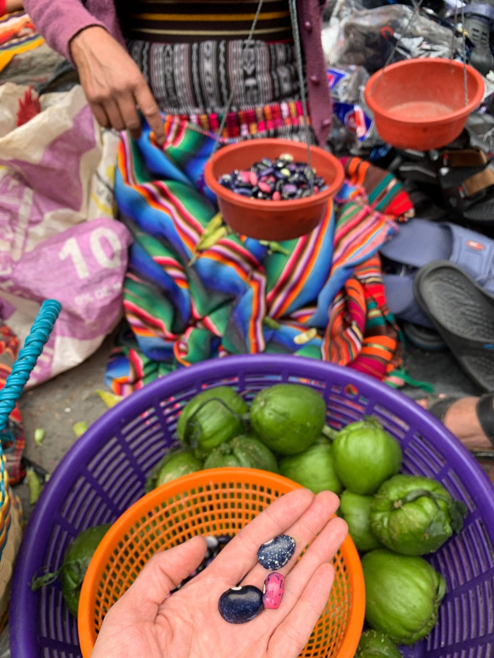 Fresh harvest of colorful beans are weighed at the market in Chichicastenango
