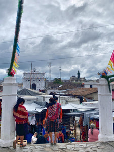 A woman carries her baby on her back in Chichicastenango