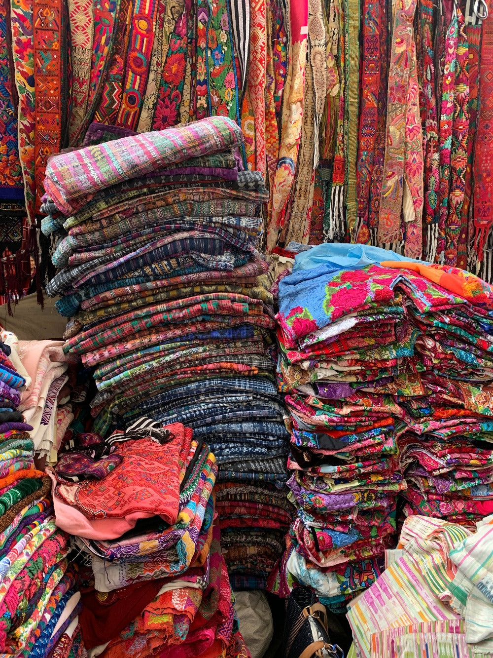 A vibrant stack of vintage textiles at the Chichicastenango market