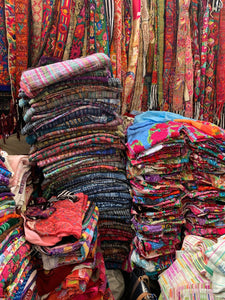 A vibrant stack of vintage textiles at the Chichicastenango market