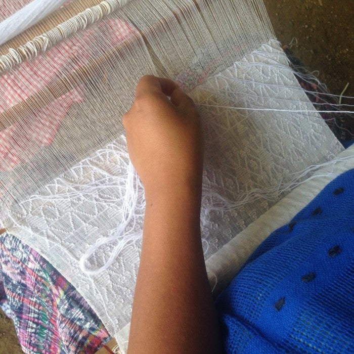 woman working in a  white loom