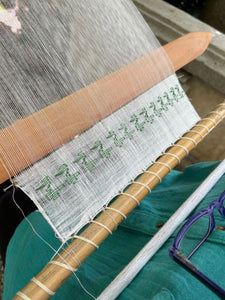 Weaving loom with green pattern brocade