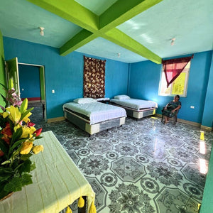 Spacious room with natural light and two double beds. Towels are available.