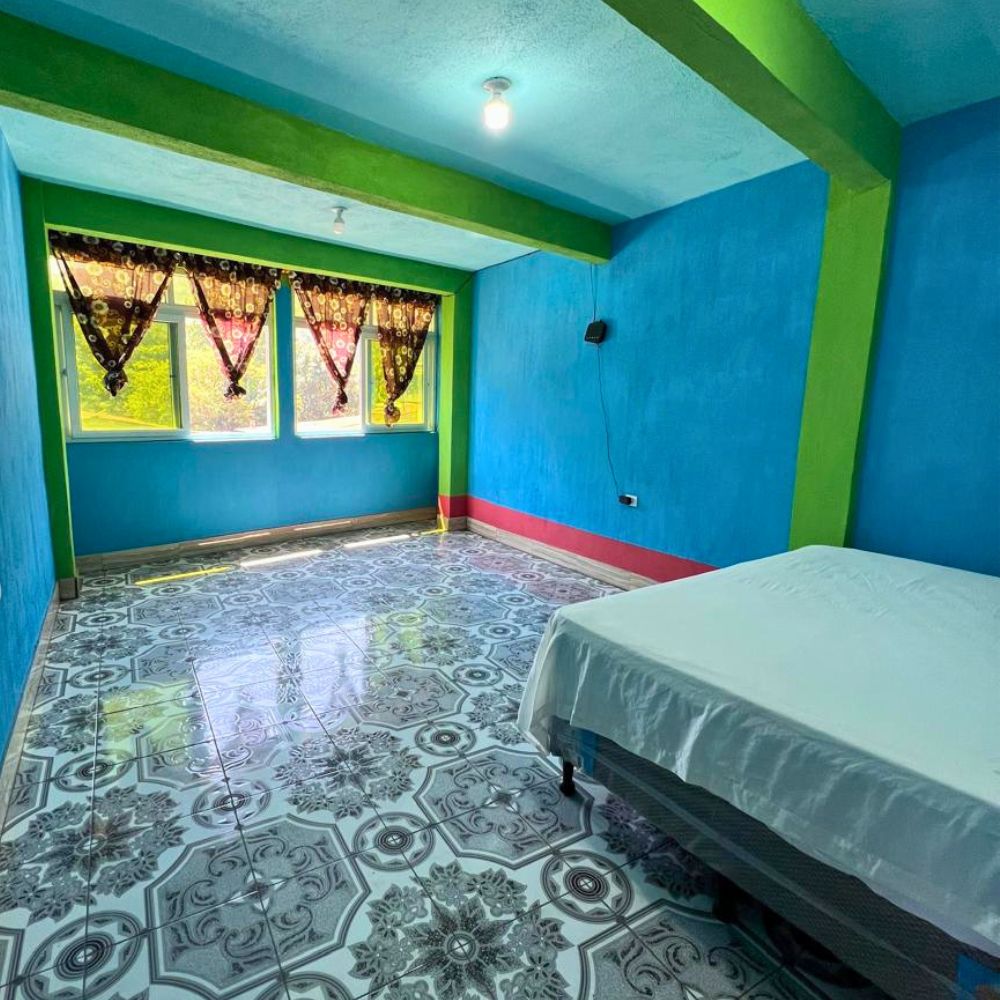 Second room with a double bed, spacious and bright.