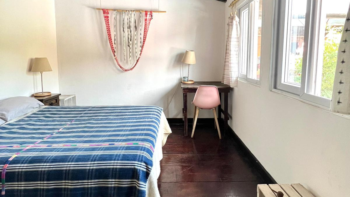 The Garden Guest Room comes with a full size bed, a desk and chair, lamps, and closet.