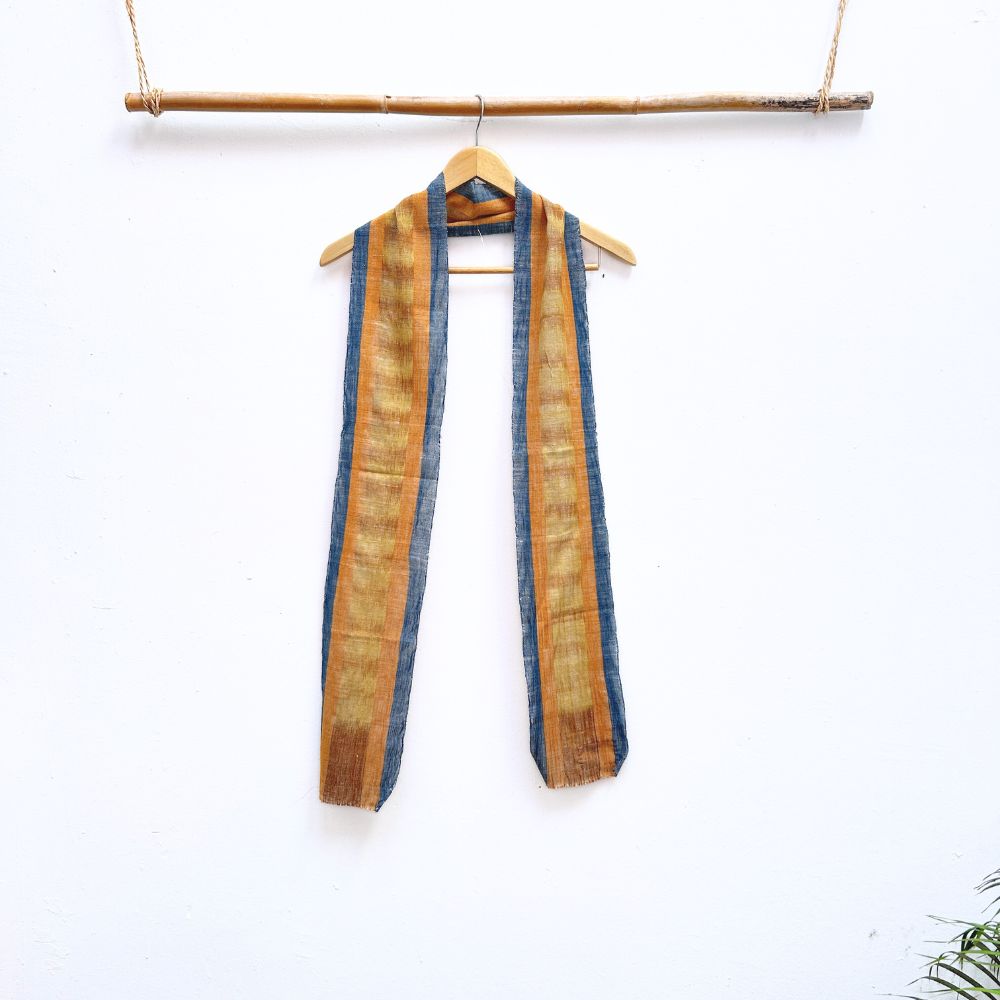Striped scarf hanging on a wooden rod against a white background