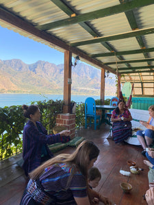 Cotton spinning class held at our hotel balcony with a lake view