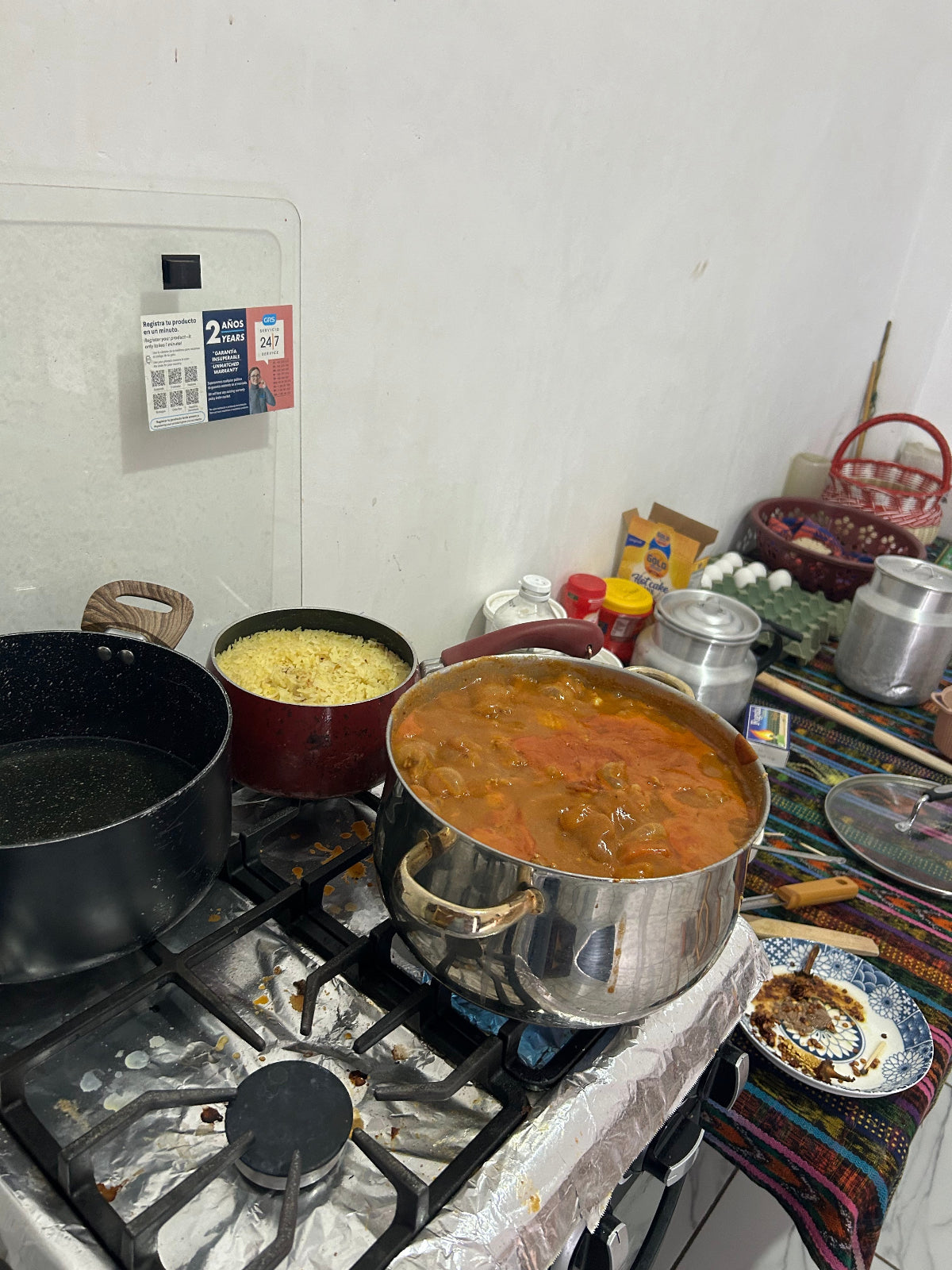Stove with several pots cooking pepián, a traditional Guatemalan dish.
