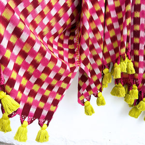 Checkered fabric with yellow tassels on a white background
