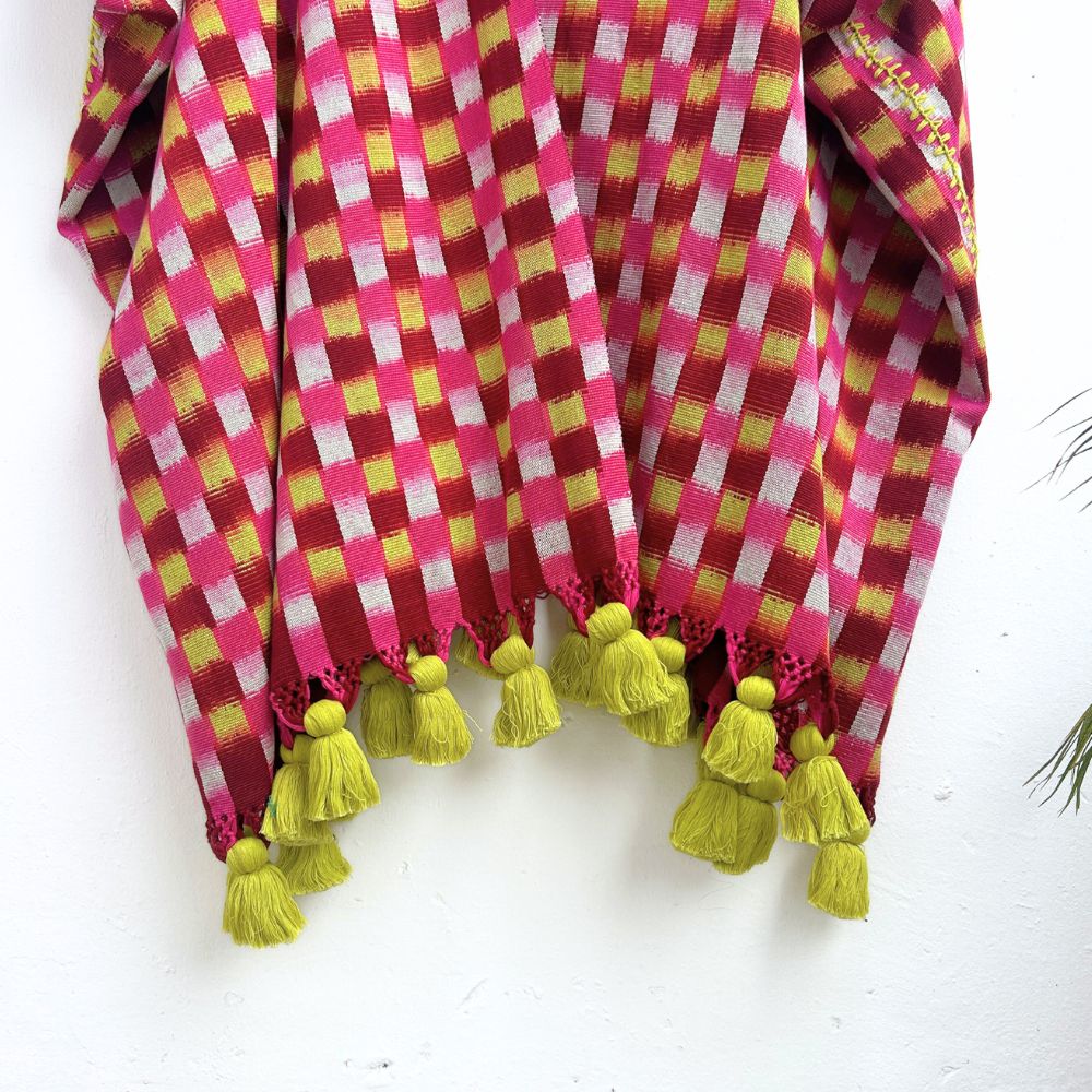 Checkered fabric with yellow tassels on a white background