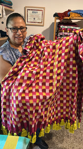 Embroidery artist Claribel shows her work of joining of the panels by holding the garment up with her hands