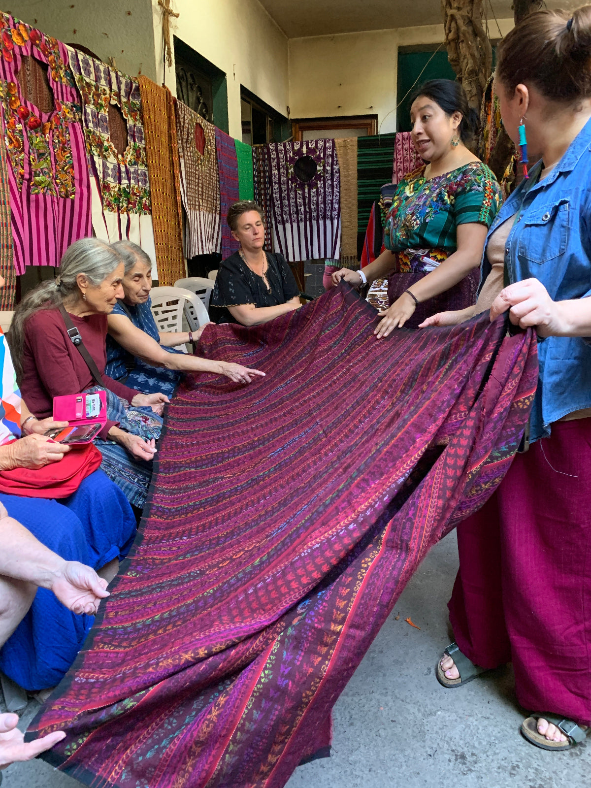 Group of people examining an intricate traditional corte 