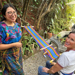 Teacher and student beginning to weave on the loom that the student created in our garden.