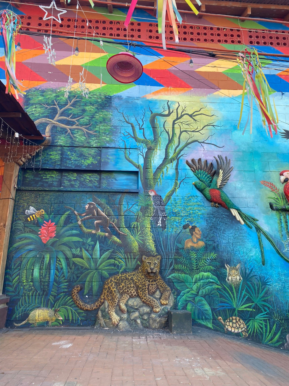 Colorful mural depicting a tropical scene with native animals and a woman