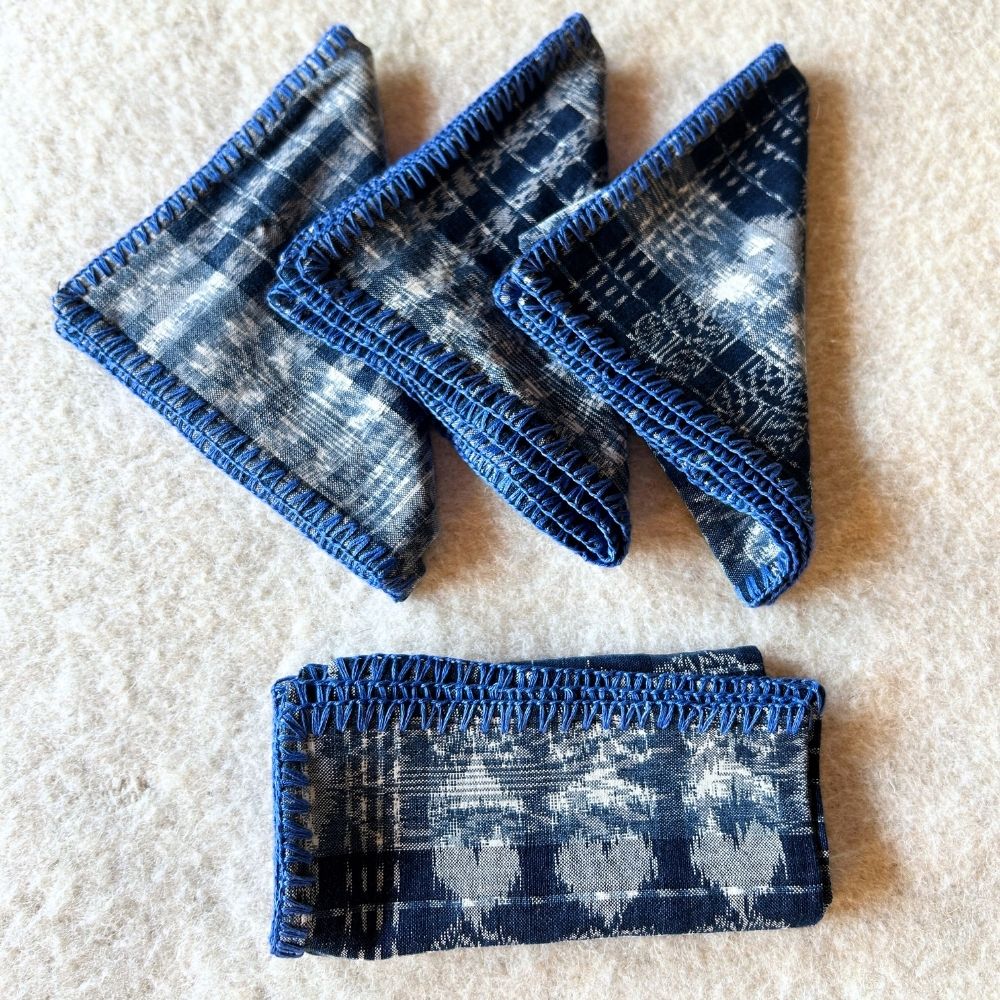 Hand-embroidered Corte Napkins: Light Indigo on blue (set of 4)