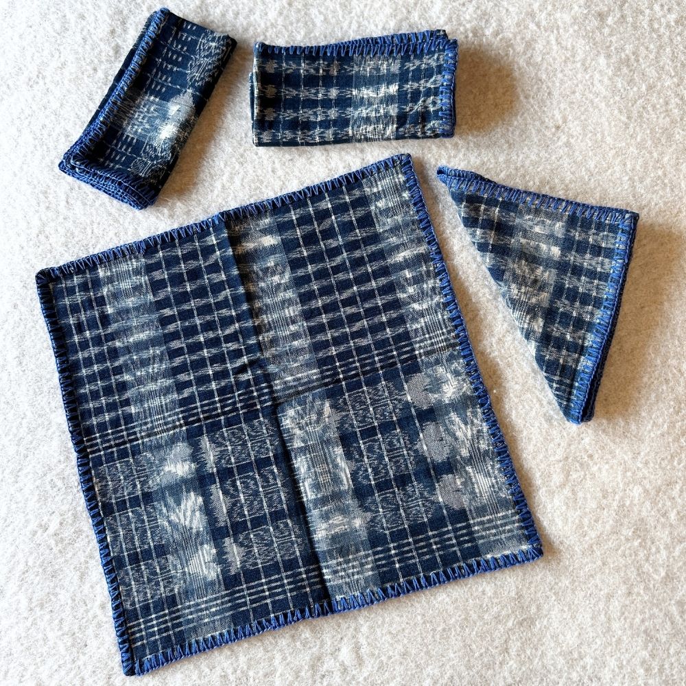 Hand-embroidered Corte Napkins: Light Indigo on blue (set of 4)