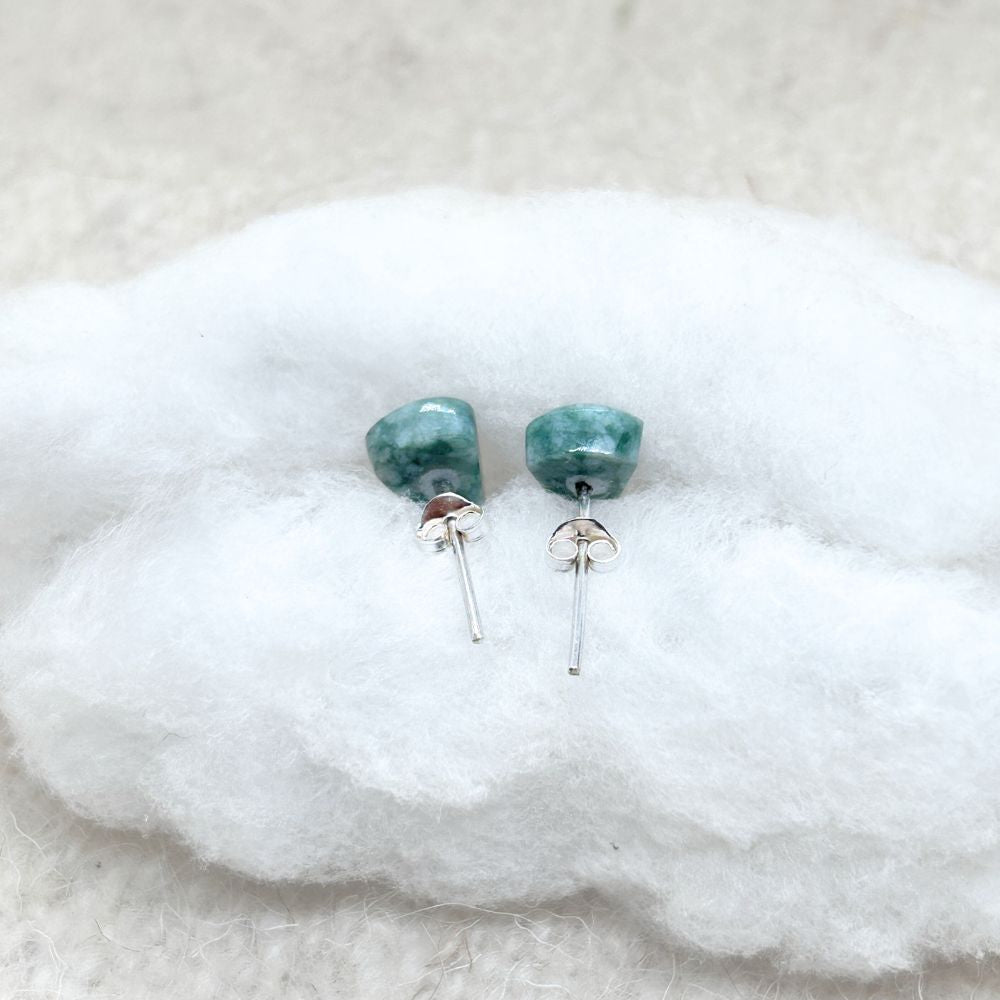 Jade  earrings on a white fabric background
