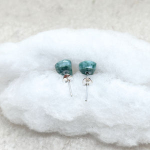 Jade  earrings on a white fabric background