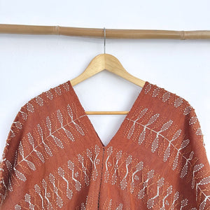 Two-panel blouse in soft brown with handspun threads, brocade figures of leaves.