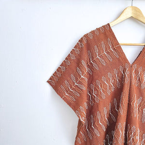 Two-panel blouse in soft brown with handspun threads, brocade figures of leaves.