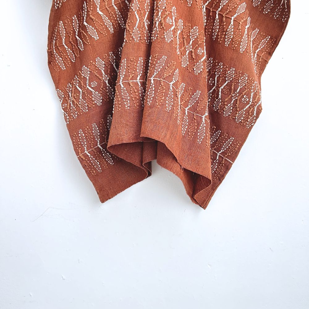 Two-panel blouse in soft brown with handspun threads, brocade figures of leaves.