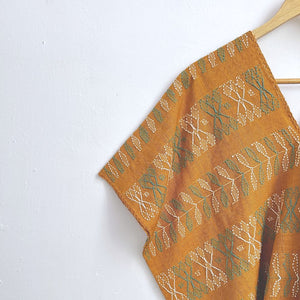 Two-panel blouse in mustard yellow with handspun threads, brocade figures of leaves.