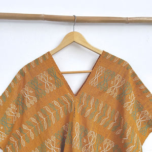 Two-panel blouse in mustard yellow with handspun threads, brocade figures of leaves.