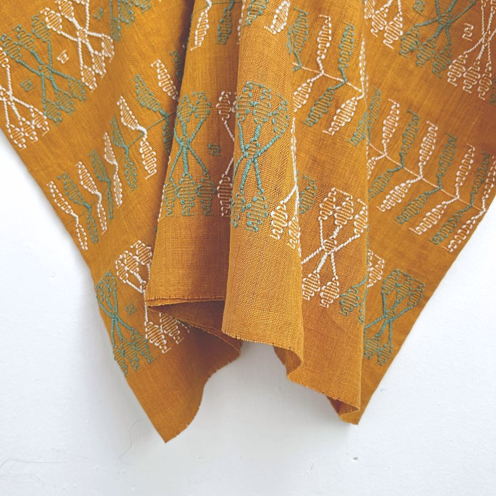 Two-panel blouse in mustard yellow with handspun threads, brocade figures of leaves.