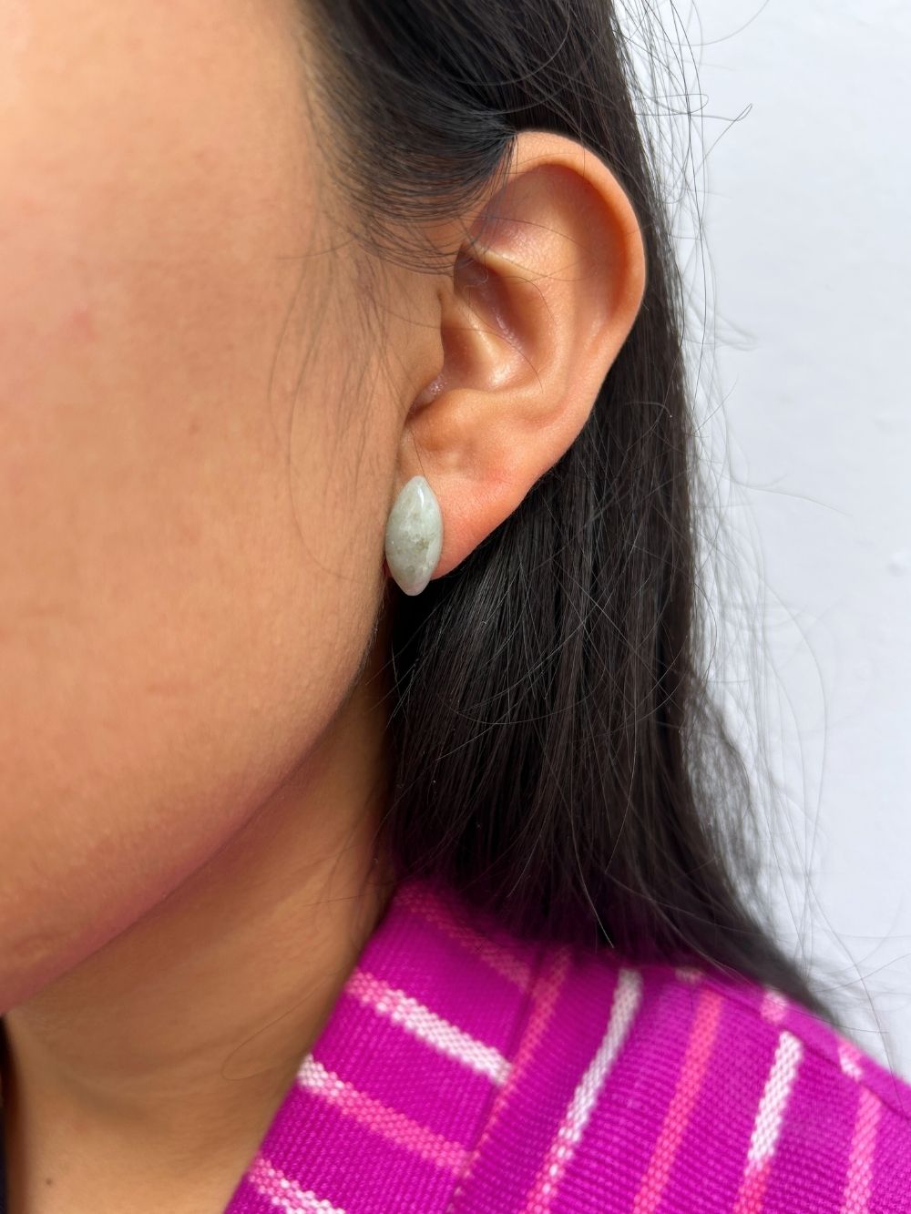 Close-up of an ear wearing a Pointed Oval-Shaped Light Green Jade Stud Earrings