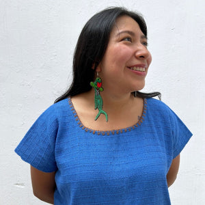 Model wearing a long tale quetzal earring 