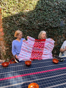 Two women sharing a beautiful Tactic garment purchased on the trip