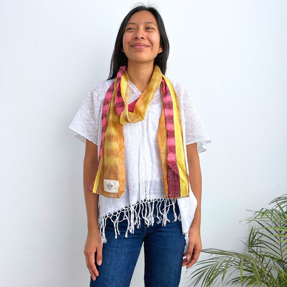 Woman wearing a colorful scarf with a white background