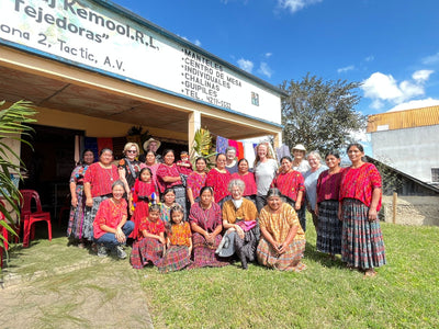 A group picture with traditional weavers all in red huipiles.