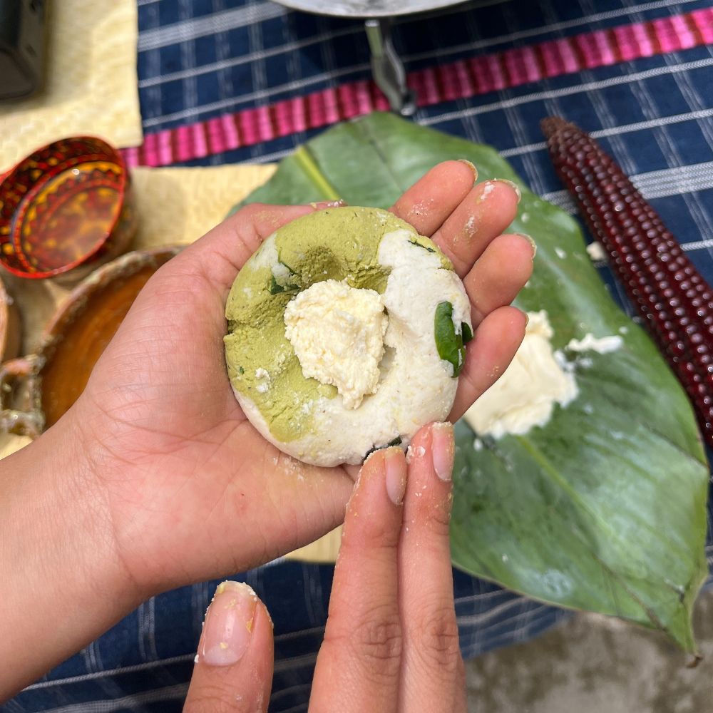 Hand molding the dough for a tamal.